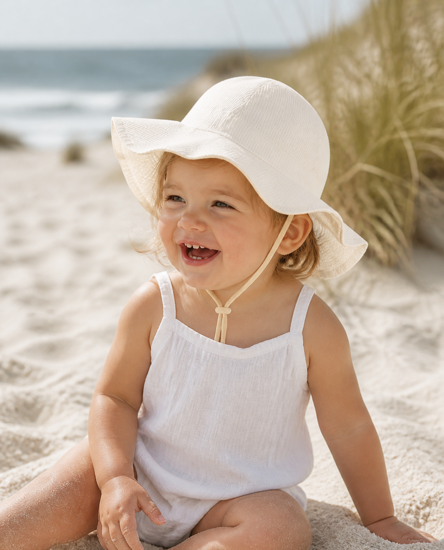Baby in a striped wide brim sun hat