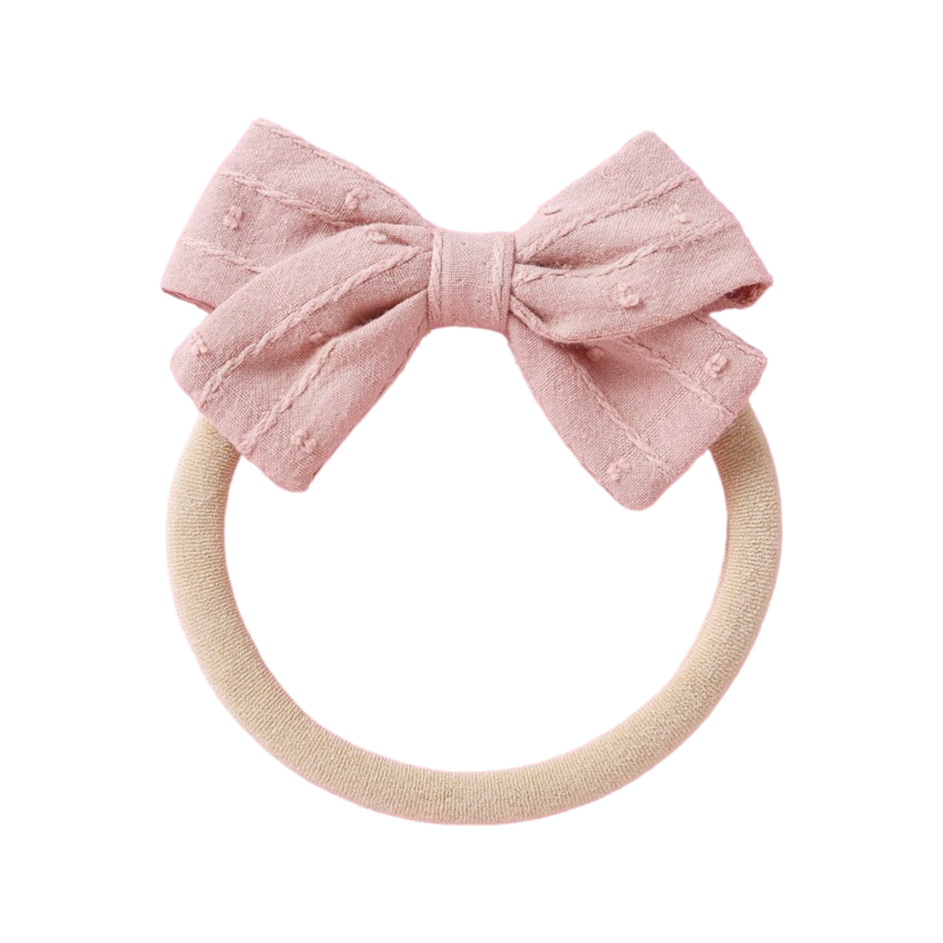 Styled peach baby accessory flat lay — Dotty Embroidered Cotton Baby Bow