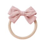 Styled lilac baby accessory flat lay — Dotty Embroidered Cotton Baby Bow