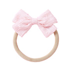 Styled flamingo baby accessory flat lay — Dotty Embroidered Cotton Baby Bow