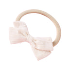 Dotty Embroidered Cotton Baby Bow in Lilac — close-up of embroidered on lilac baby accessory