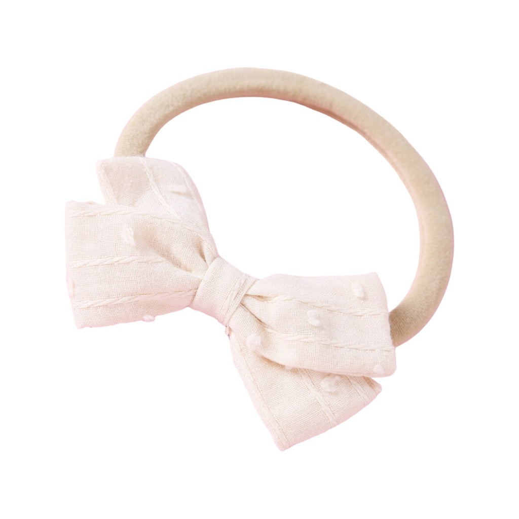 Dotty Embroidered Cotton Baby Bow in Lemon — close-up of embroidered on lemon baby accessory
