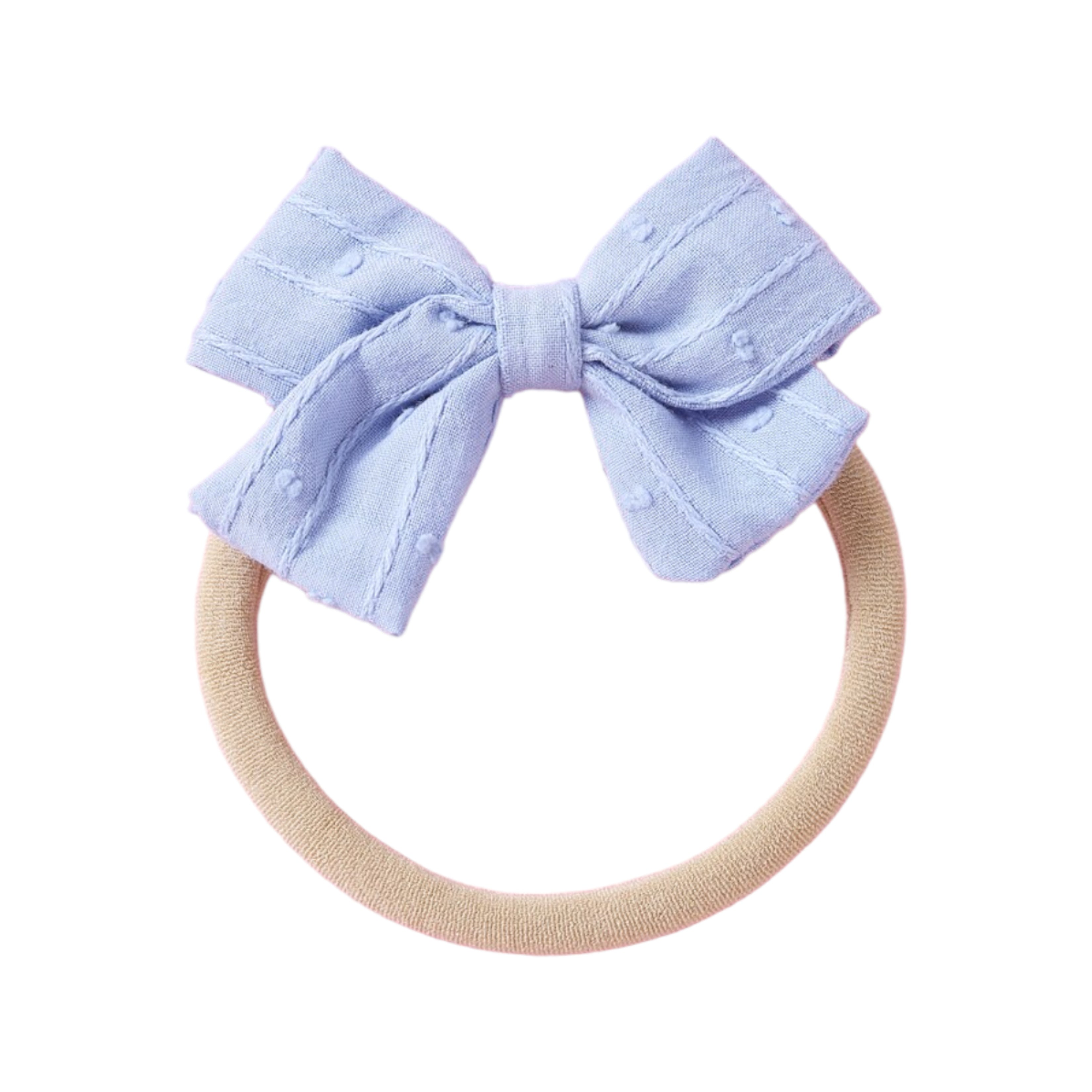 Dotty Embroidered Cotton Baby Bow in White — baby accessory styled flat lay with nursery accessories