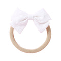White cotton embroidered baby accessory — Dotty Embroidered Cotton Baby Bow on white background