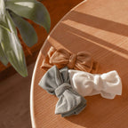 Baby girl wearing sand baby headband with oversized bow — Winnie Waffle Headband