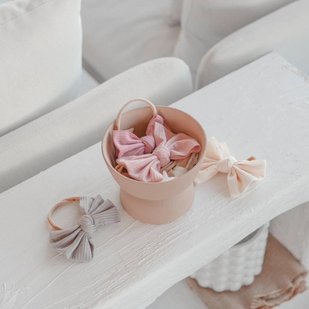 Baby girl wearing blush baby headband with textured — Baby Mini Textured Bow Headband