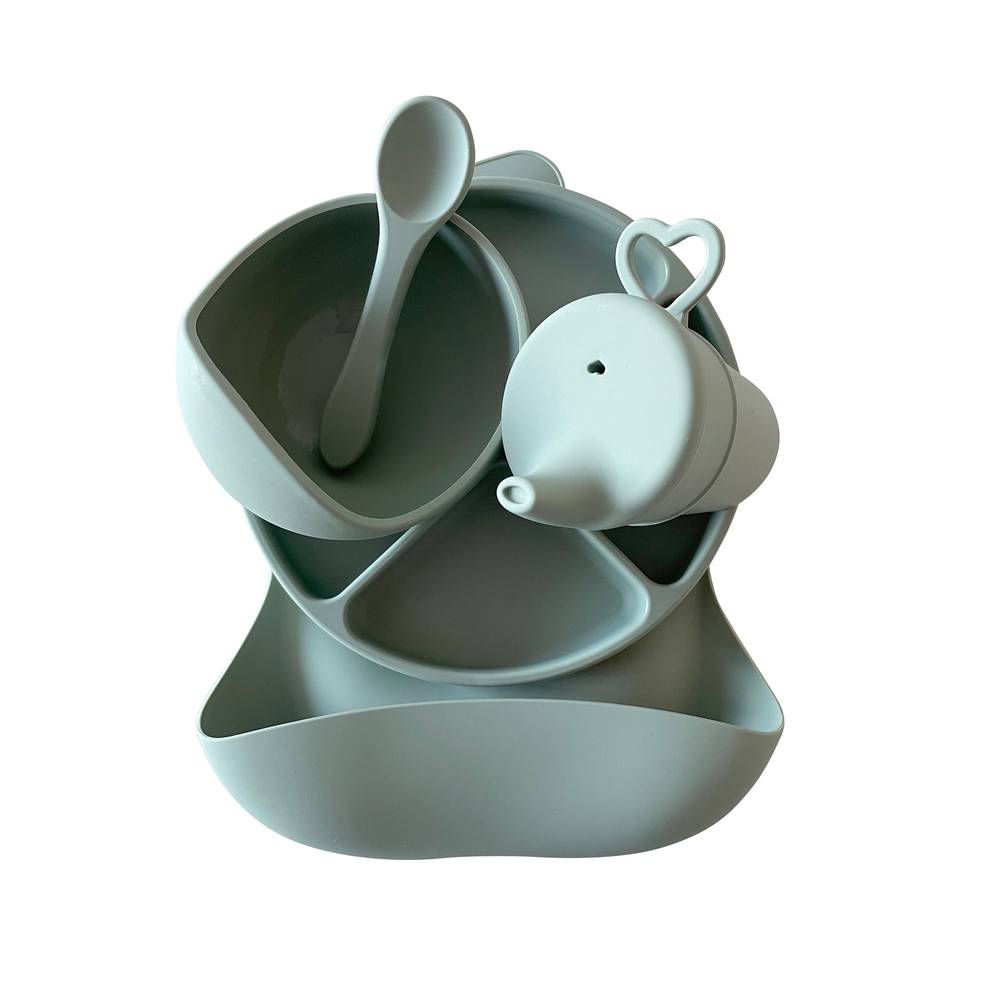Silicone Baby Feeding Set in Chalet Green — baby bib styled flat lay with nursery accessories