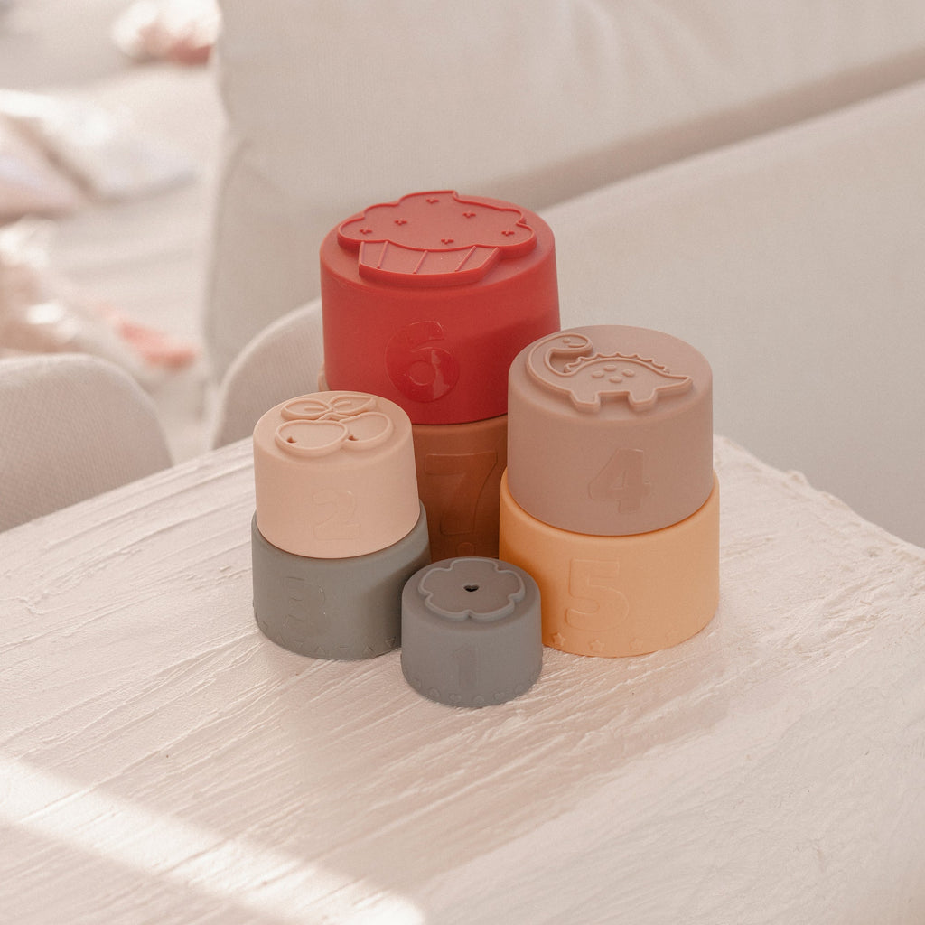 Silicone Baby Stacking Cups Bath & Beach in Earthy — baby hat size and scale reference