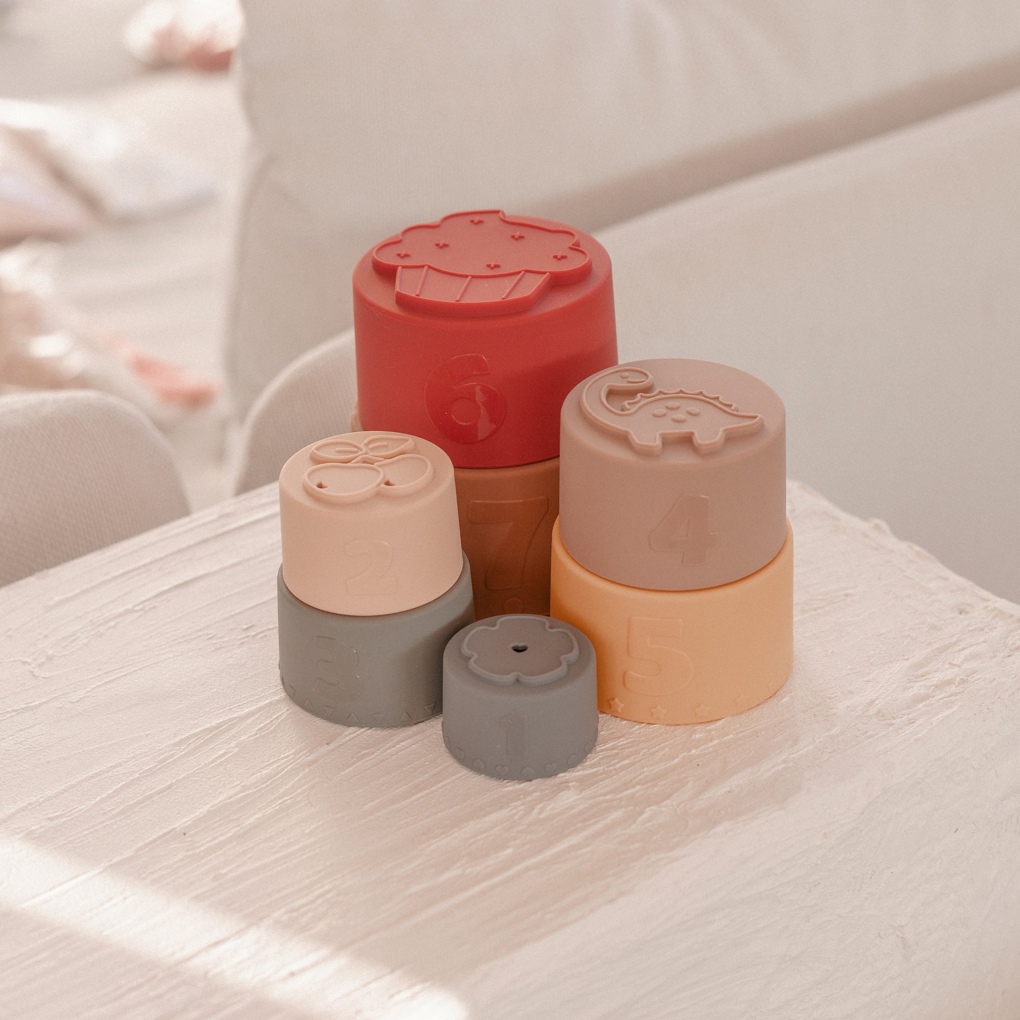 Silicone Baby Stacking Cups Bath & Beach in Earthy — baby hat size and scale reference