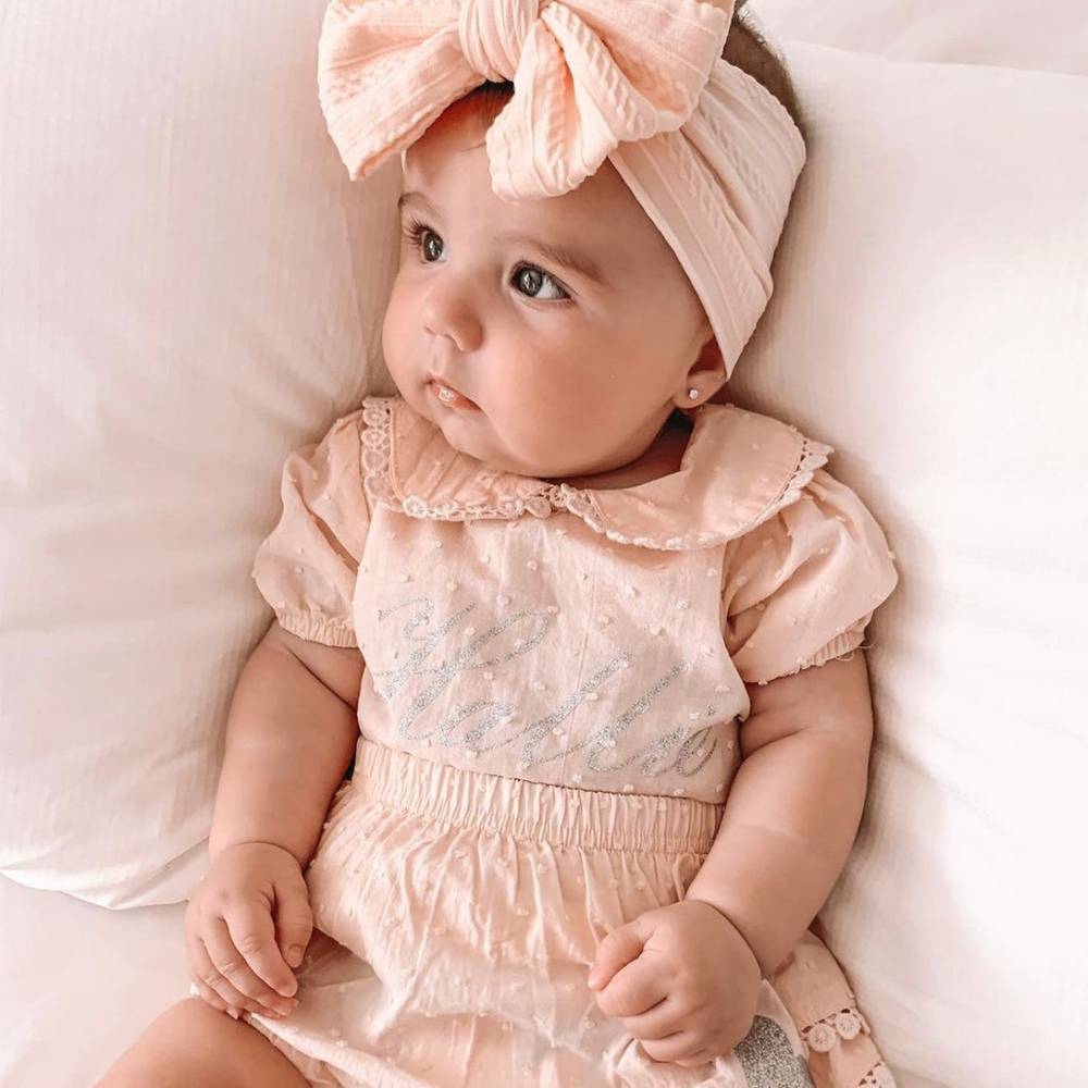 Bowie Double Bow Headband in Coral — close-up showing nylon texture and craftsmanship