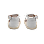 Baby feet in baby sandals on soft surface — Coconut White Leather Baby Bow Sandal