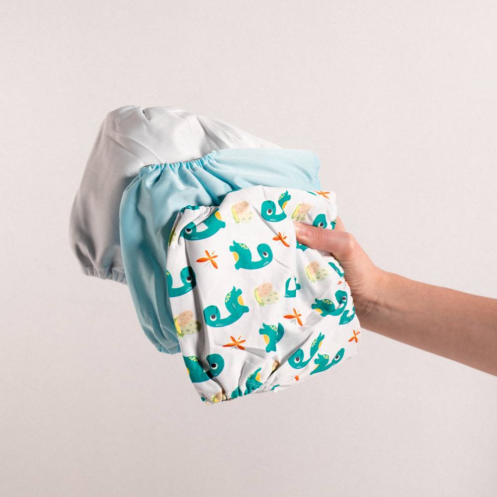 "Georgie Porgie" Dino Nappy Trio — Unisex Baby Gift Bundle — close-up of check on baby gift set