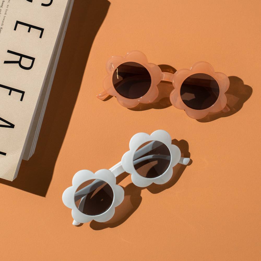 June Flower in Snow White Sunglasses — close-up of floral on snow white sunglasses baby sunglasses