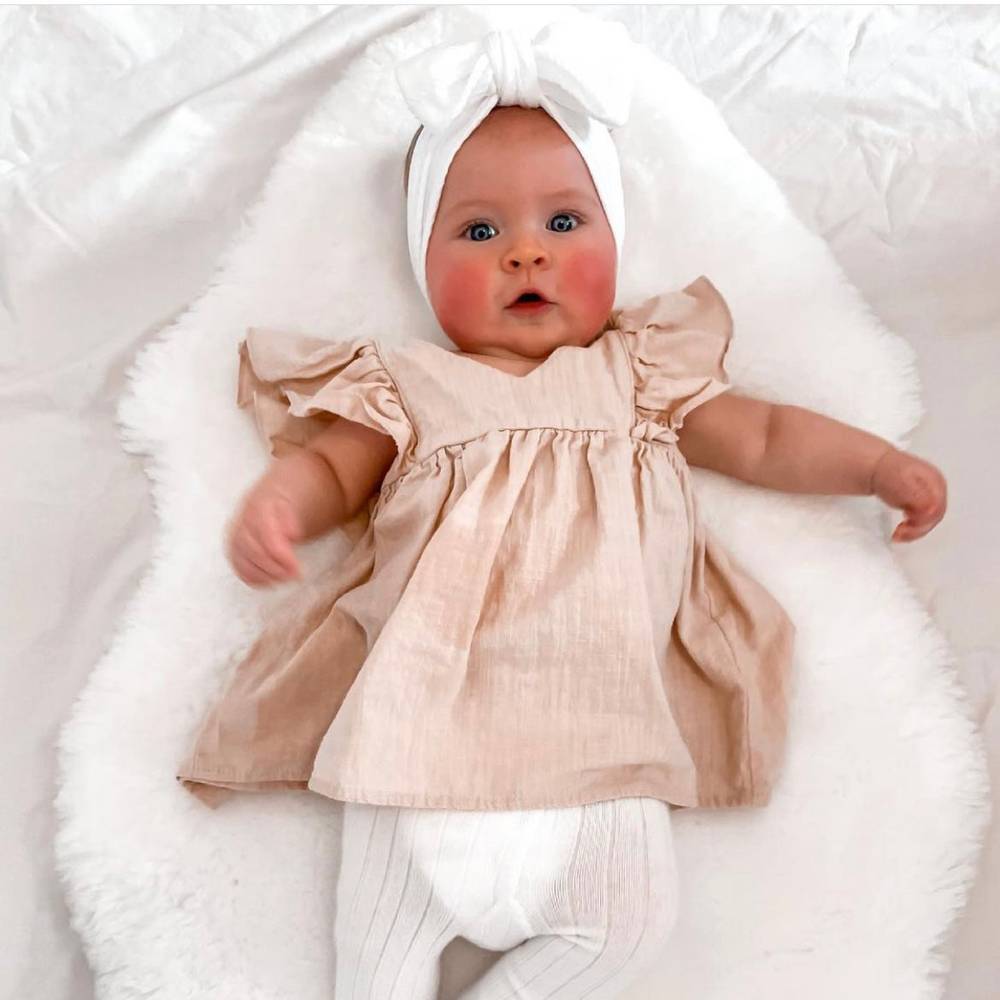 Bowie Double Bow Baby Headband in White — baby headband size and scale reference