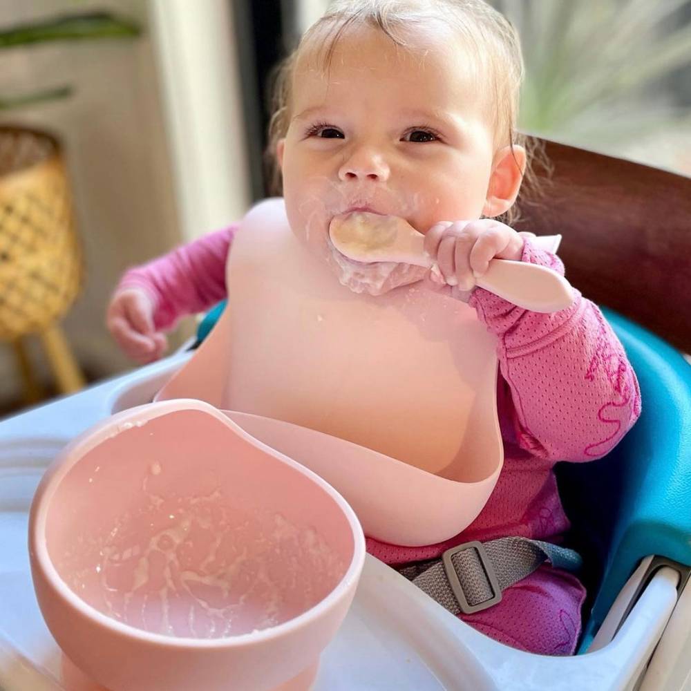 Silicone Baby Feeding Set in Cherry Blossom — cat baby bib showing face and soft texture