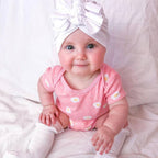 Newborn wearing white baby turban with ear detail — Baby Triple Knot Turban