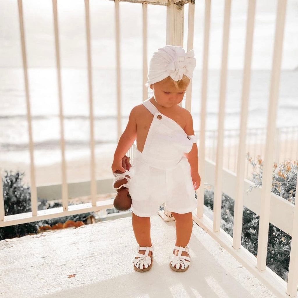 White Leather Baby Sandal — baby sandals styled flat lay with nursery accessories
