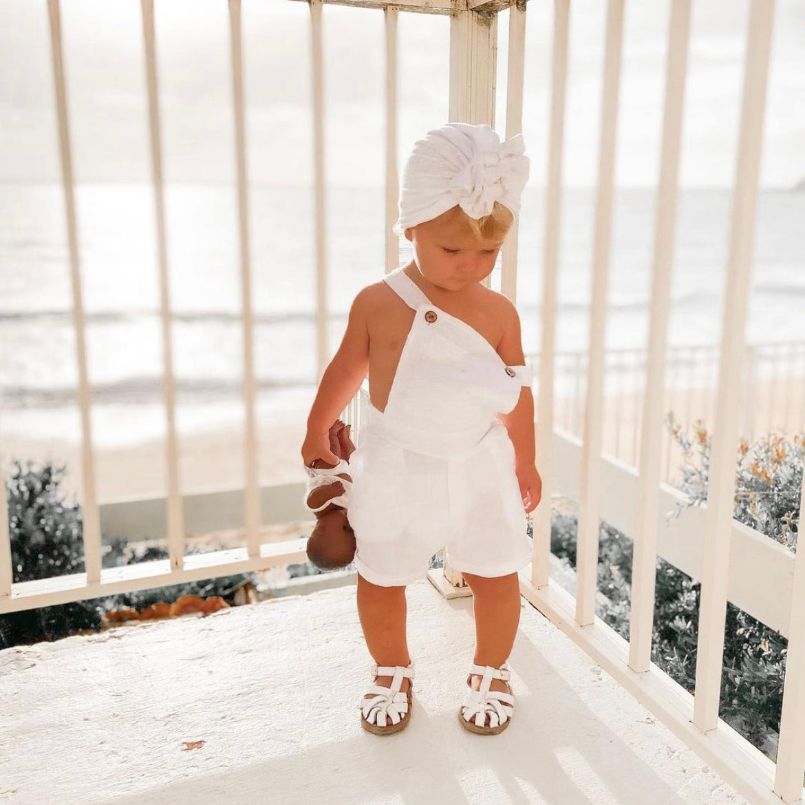 White Leather Baby Sandal — baby sandals styled flat lay with nursery accessories