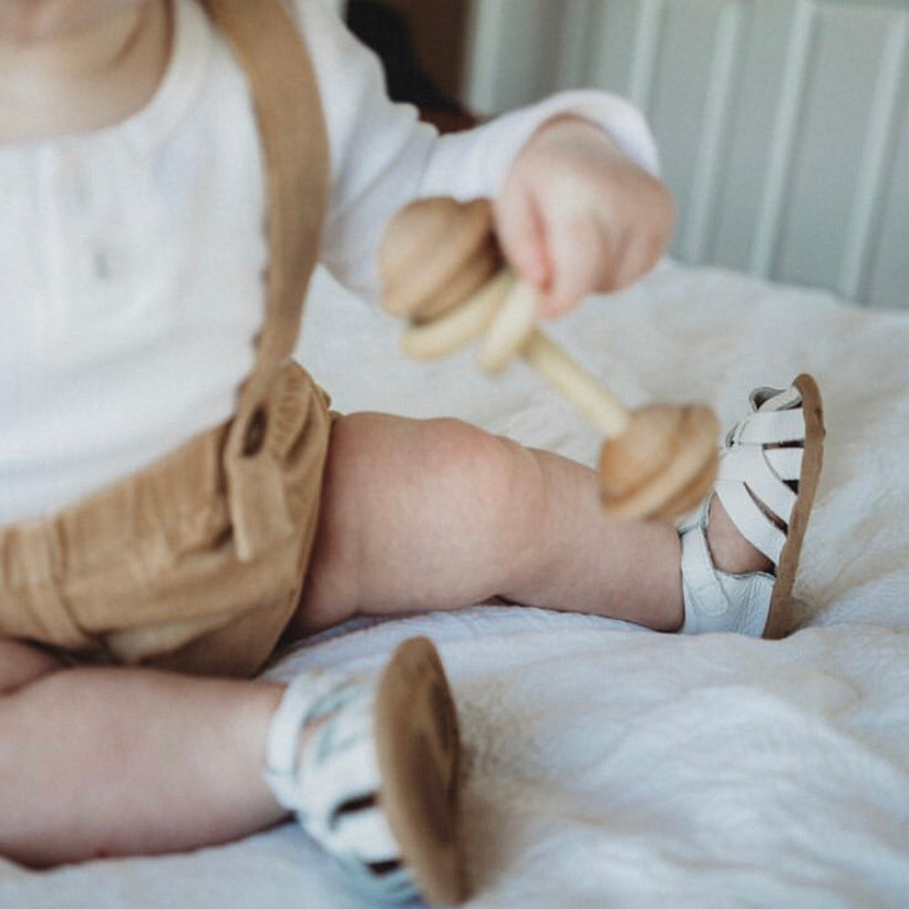 White Leather Baby Sandal — baby sandals styled flat lay with nursery accessories