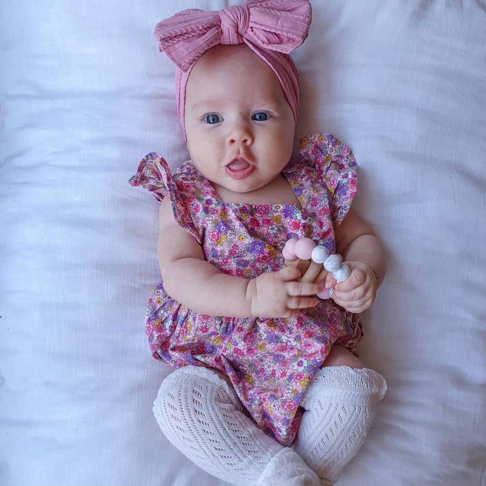 Bowie Double Bow Headband in Flamingo Pink — baby headband close-up showing nylon