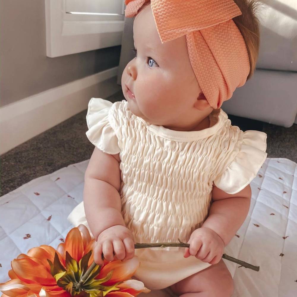 Baby Adjustable Bow Headband in Flamingo — detail shot showing fabric texture and quality