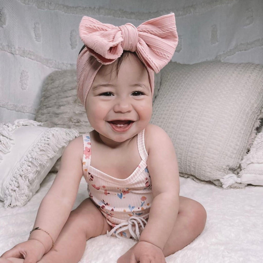 Bowie Double Bow Headband in Powder Blue — baby headband styled flat lay with nursery accessories
