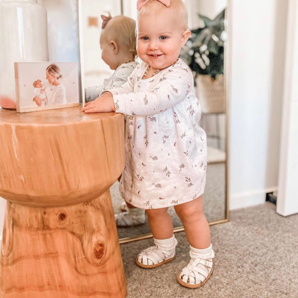 White Leather Baby Sandal — baby sandals styled flat lay with nursery accessories