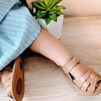 Tawny Weave Leather Baby Sandal — baby sandals styled flat lay with nursery accessories