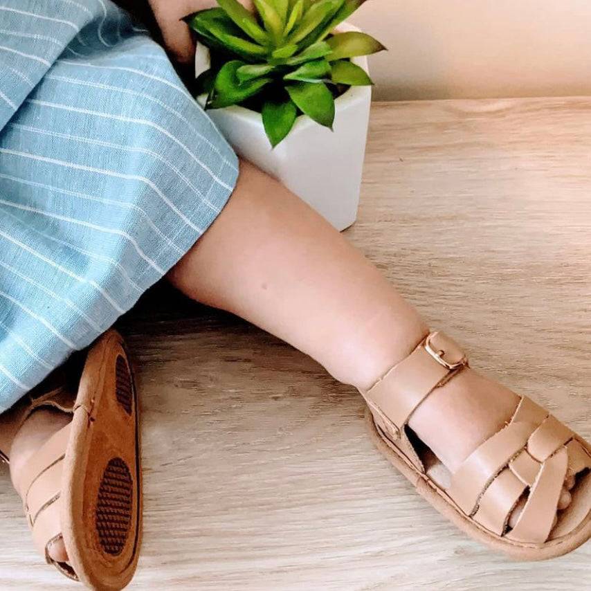 Tawny Weave Leather Baby Sandal — baby sandals styled flat lay with nursery accessories