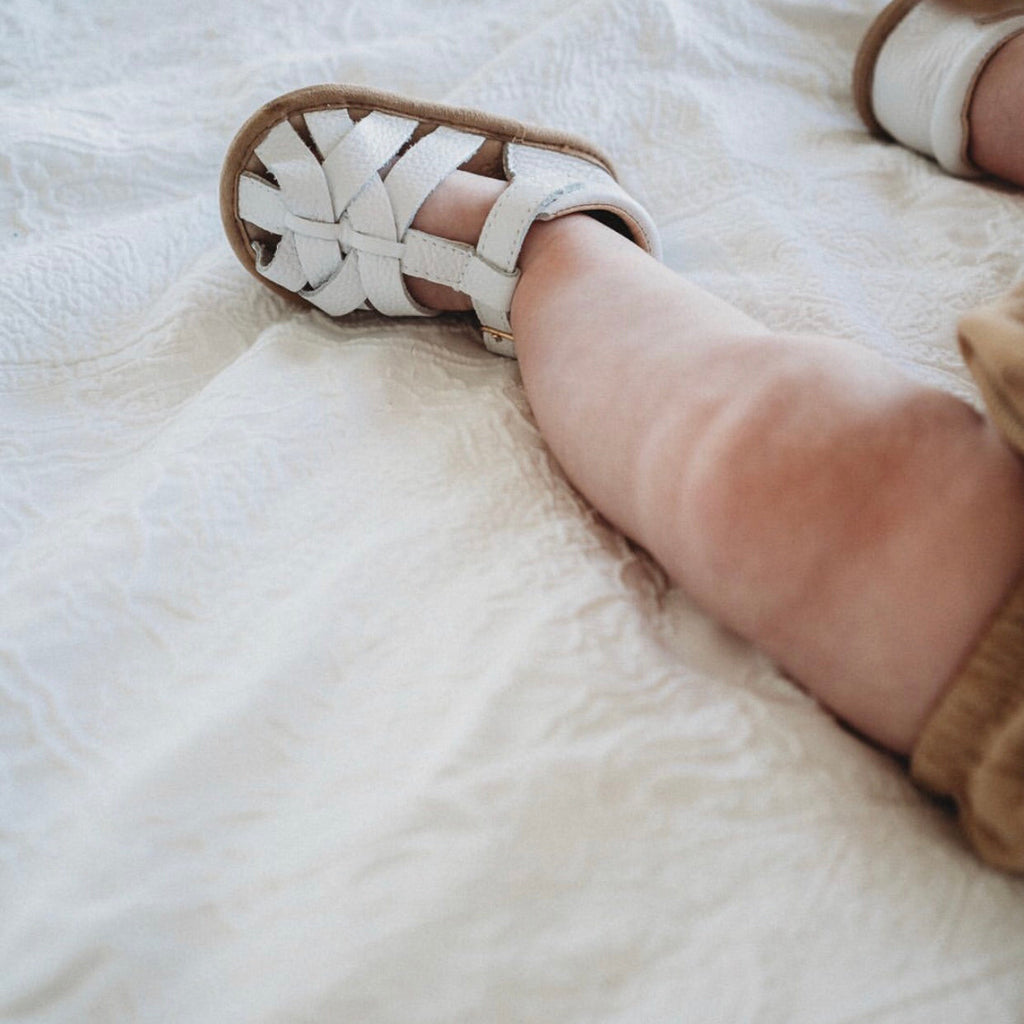 White Leather Baby Sandal — baby sandals styled flat lay with nursery accessories