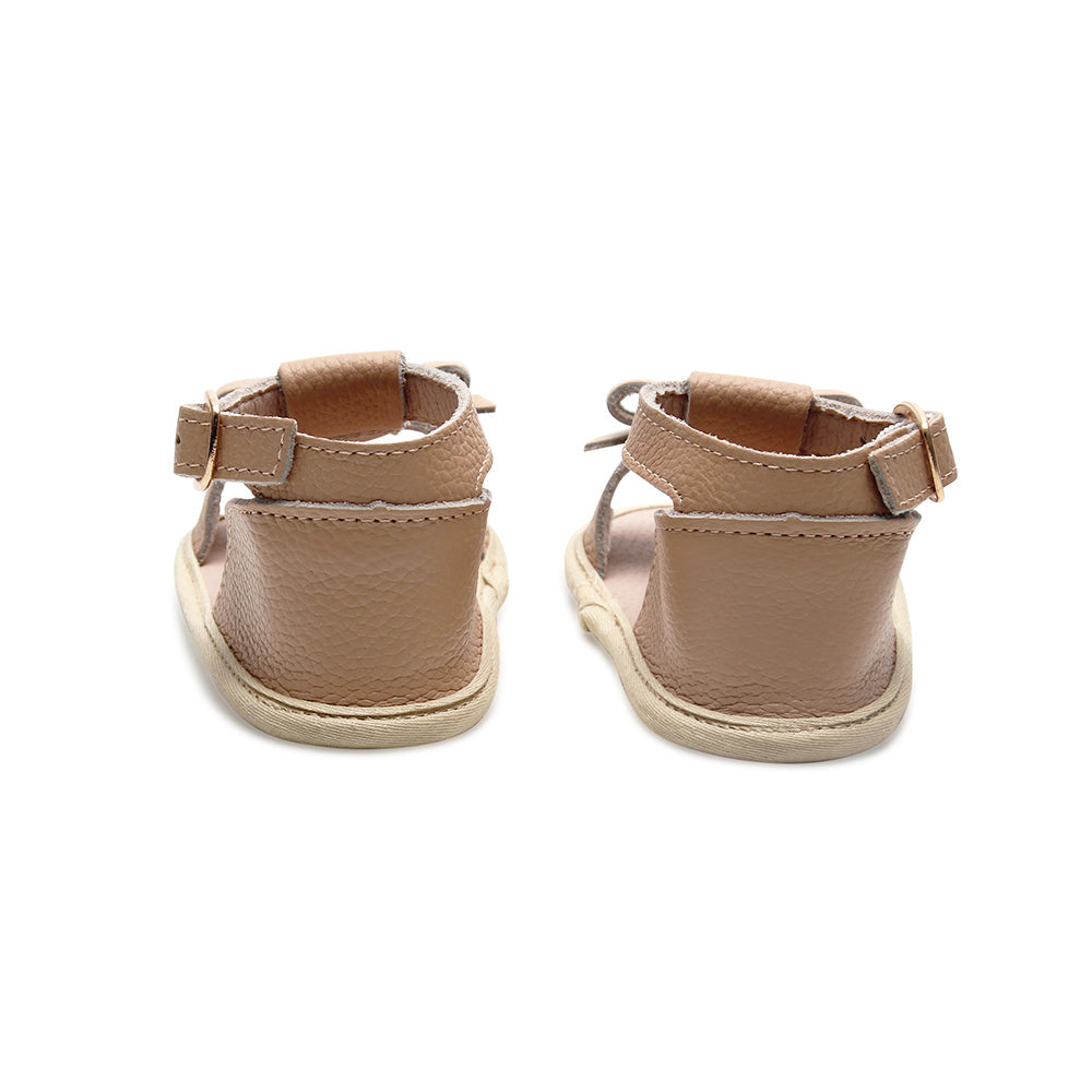Baby feet in baby sandals on soft surface — Pale Pecan Leather Baby Bow Sandal