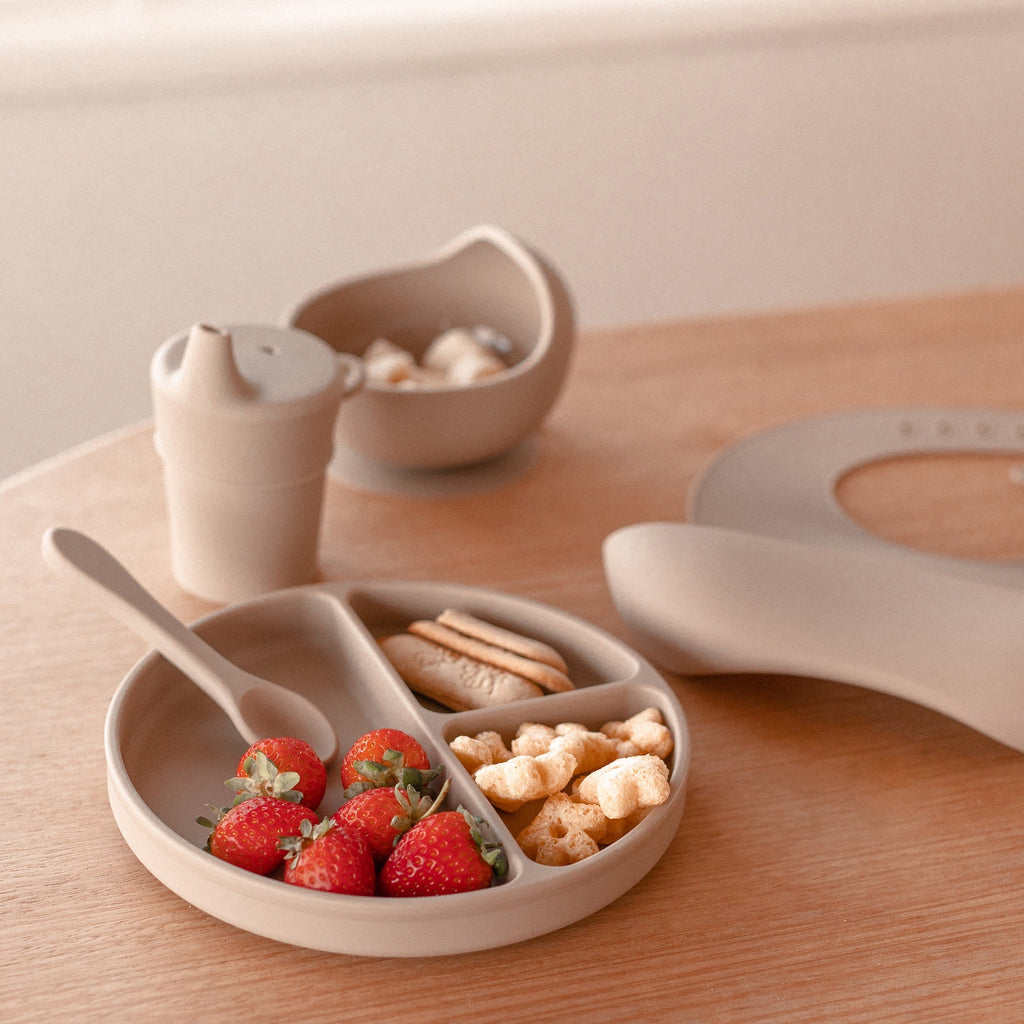 Baby wearing sand dune baby bib during mealtime — Silicone Baby Feeding Set