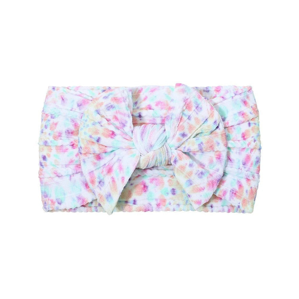 Cable knit floral baby headband with bow detail — Single Bow Cable Knit Baby Headband Floral Design #2 on white background