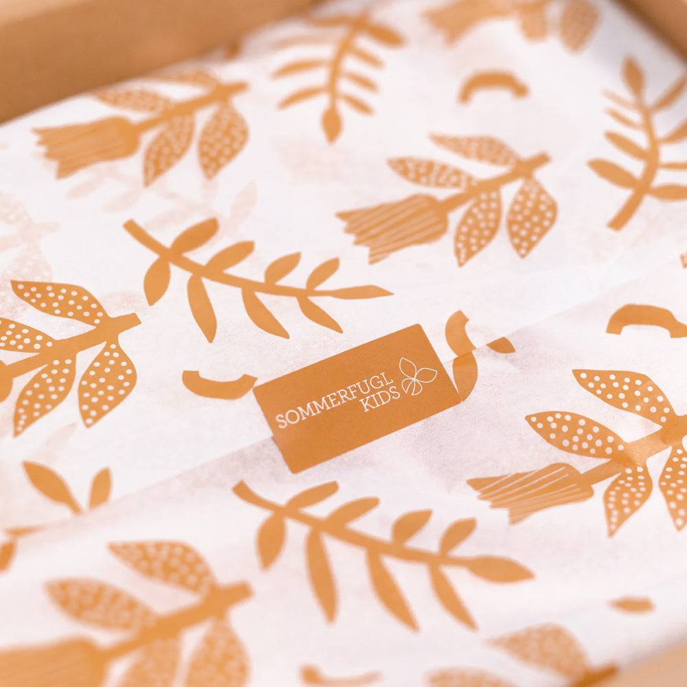 Styled baby gift set flat lay — "Happy and You Know It" Tropics Nappy & Moccs — Baby Girl Gift Bundle