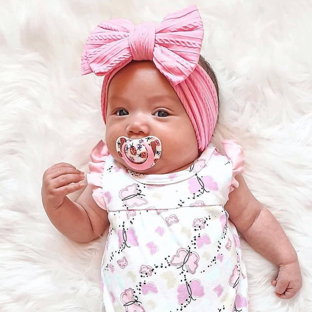 Bowie Double Bow Baby Headband in White — close-up showing nylon texture and craftsmanship