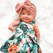 Bowie Double Bow Headband in Rouge Red — baby headband styled flat lay with nursery accessories