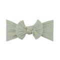 Ivory nylon ear detail baby headband with bow detail — Bowie Single Bow Headband on white background