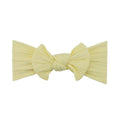 Lemon yellow nylon ear detail baby headband with bow detail — Bowie Single Bow Headband on white background