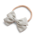 Beige cotton baby hat — Tinka Tiny Bow on white background