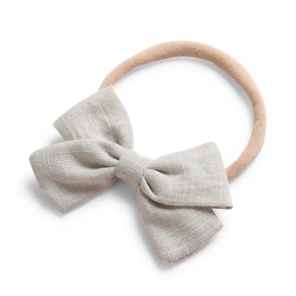 Beige cotton baby hat — Tinka Tiny Bow on white background