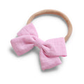 Blush cotton baby hat — Tinka Tiny Bow on white background