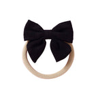 Black knit textured baby headband with bow detail — Baby Small Waffle Bow Headband on white background