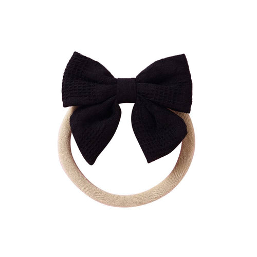 Black knit textured baby headband with bow detail — Baby Small Waffle Bow Headband on white background