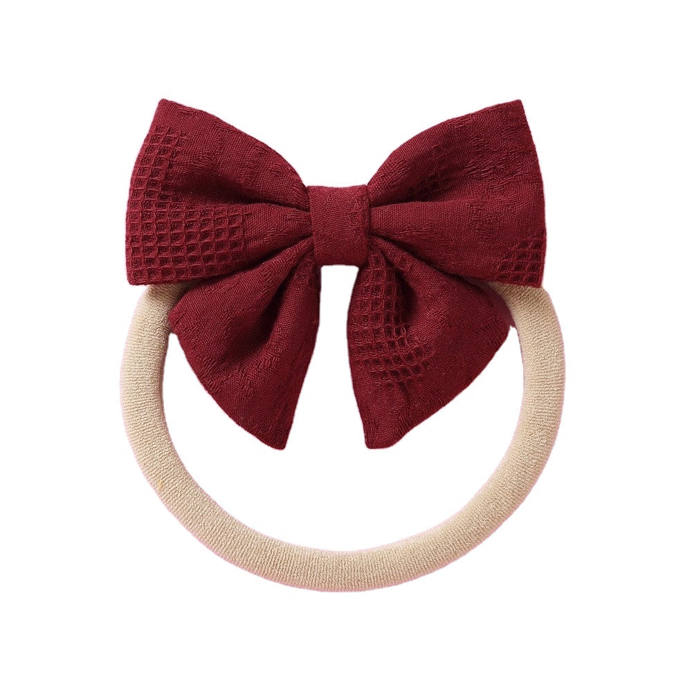 Cherry knit textured baby headband with bow detail — Baby Small Waffle Bow Headband on white background