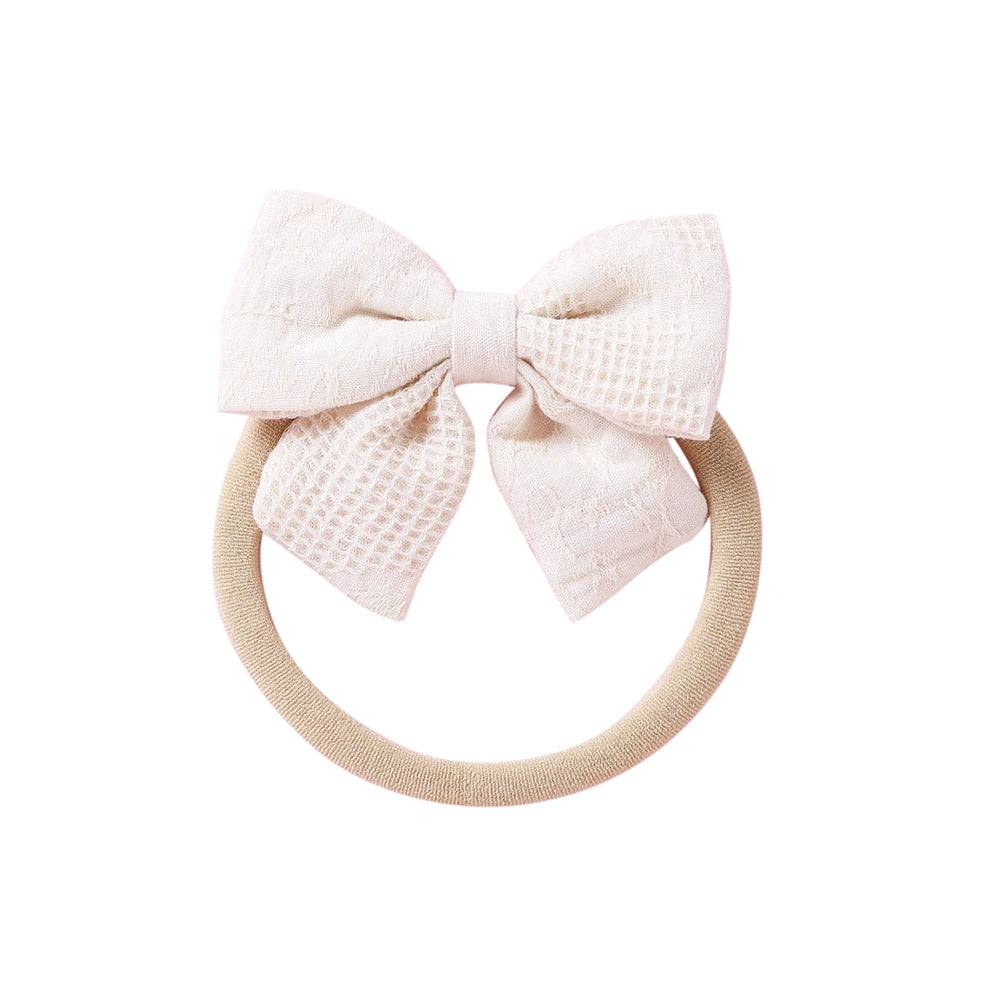 Ivory knit textured baby headband with bow detail — Baby Small Waffle Bow Headband on white background