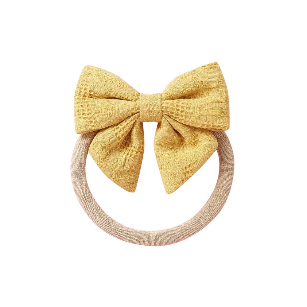 Mustard knit textured baby headband with bow detail — Baby Small Waffle Bow Headband on white background
