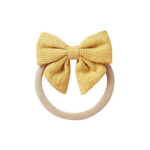 Mustard knit textured baby headband with bow detail — Baby Small Waffle Bow Headband on white background