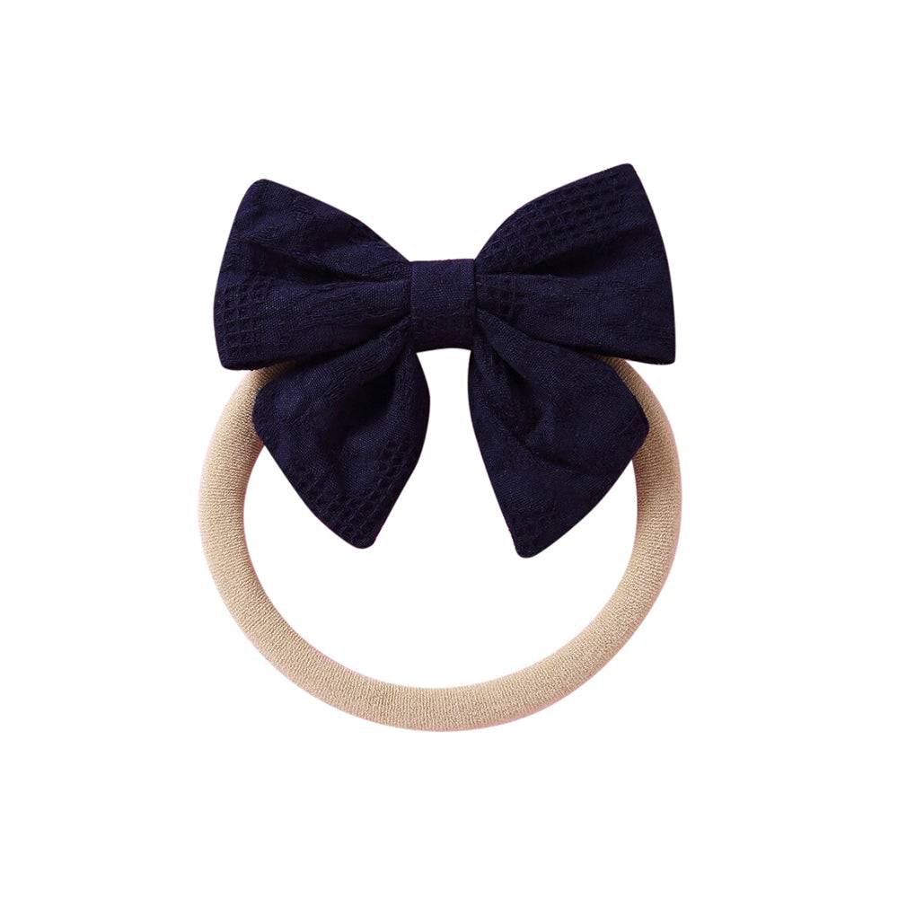 Navy knit textured baby headband with bow detail — Baby Small Waffle Bow Headband on white background