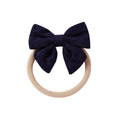 Navy knit textured baby headband with bow detail — Baby Small Waffle Bow Headband on white background
