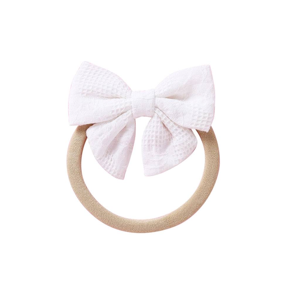 White knit textured baby headband with bow detail — Baby Small Waffle Bow Headband on white background